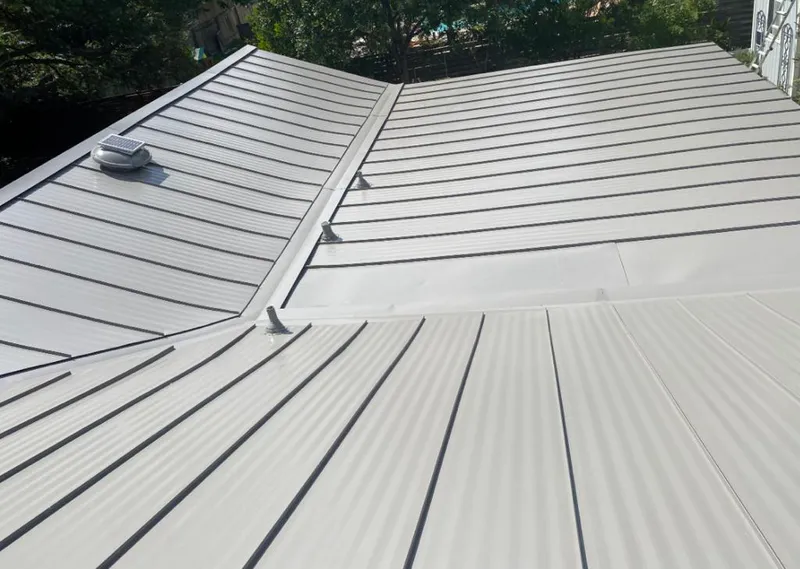 Solar attic fan installed on a metal roof for Roof Ventilation in Mount Rainier