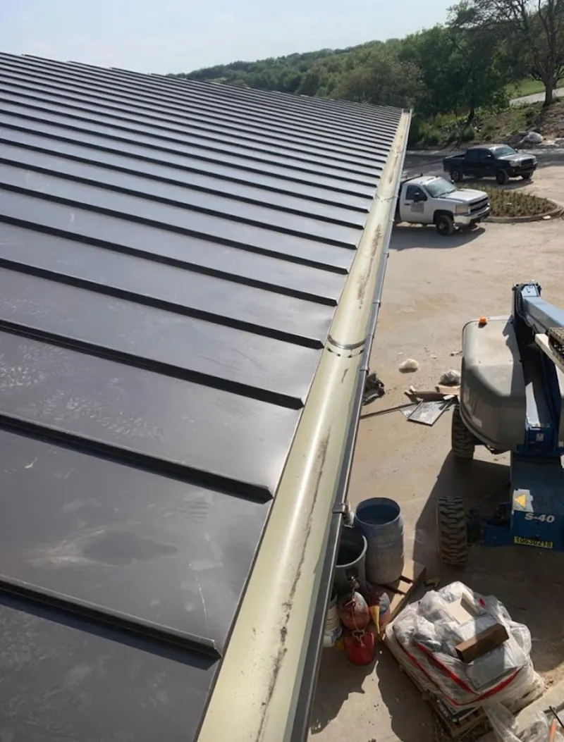 Standing seam panel and gutter detail on a metal roofing jobsite in Mount Rainier